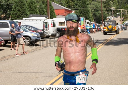 FORESTHILL CA - June 27, 2015: Ultra-marathon runner Rob Krar running in the Western States 100-mile Endurance Run, one of the oldest ultra-marathons in the US. Krar won the event in 2014 and 2015.