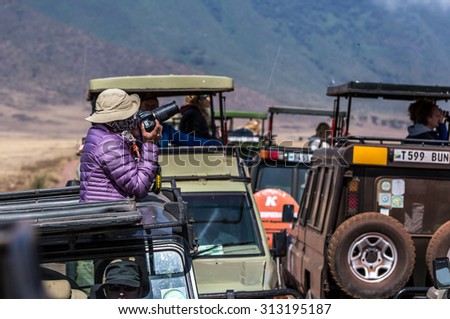 NGORONGORO ,TANZANIA - AUGUST 2nd 2015 ; Big group of tourists in safari cars enjoy the wildlife of the park. Ngorongoro Creater, Tanzania, Africa