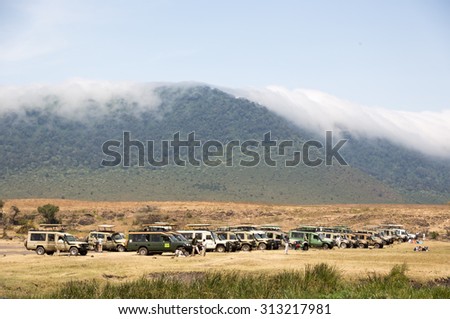 NGOROGORO ,TANZANIA - AUGUST 2nd 2015 ; Tourist and locals enjoy the lunch time in the picnic area inside the Ngorogoro Crater Conservation area in Tanzania, Africa
