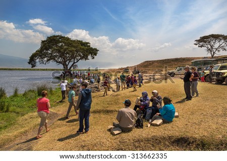 NGORONGORO, TANZANIA - AUGUST 17, 2015: Tourists enjoying a beautiful day in the picnic area of the Ngorongoro Conservation Area, Tanzania, Africa