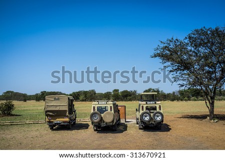 SERENGETI, TANZANIA - AUGUST 27, 2015: Safari cars waiting to clients in the Kogatende airstrip in northern Serengeti, Tanzania, Africa