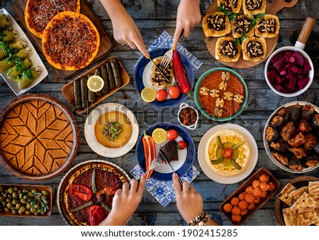 Many kinds of food and meze on the dining table. Local foods named muhammara cevizli biber and icli kofte. Traditional foods concept.  Stok fotoğraf © 