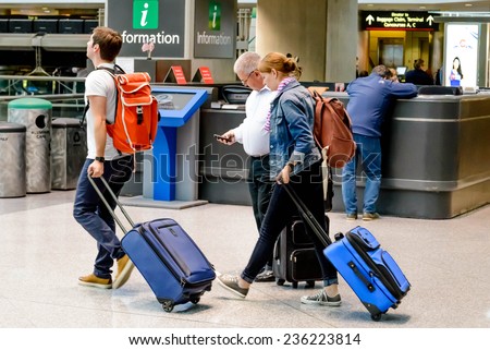 September 12, 2014: DIA, DEN, Denver International Airport, CO - people using a laptop charging station at an airport