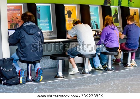 September 12, 2014: DIA, DEN, Denver International Airport, CO - people using a laptop charging station at an airport