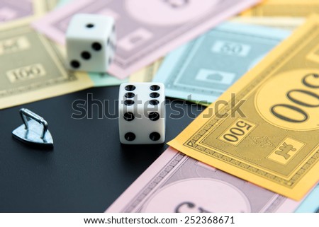 February 8, 2015: Houston, TX, USA.  Monopoly iron, dice and money