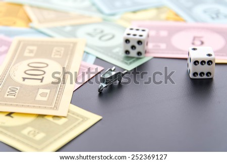 February 8, 2015 - Houston, TX, USA.  Monopoly wheelbarrow, dice and money