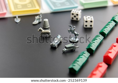 February 8, 2015 - Houston, TX, USA.  Monopoly money, playing pieces and dice