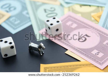 February 8, 2015 - Houston, TX, USA.  Monopoly dog, dice and money
