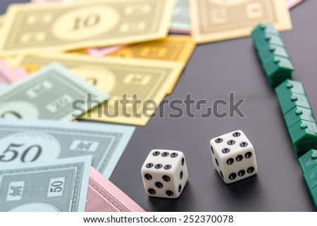 February 8, 2015 - Houston, TX, USA.  Monopoly money, playing pieces and dice