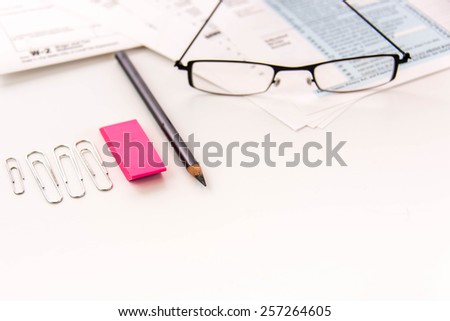 Tax preparation supplies, reading glasses and blank tax forms