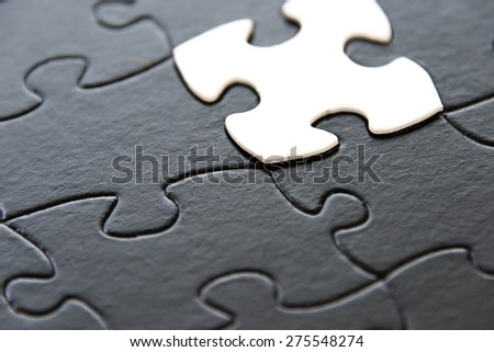 black and white puzzle pieces contrasting