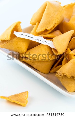 open fortune cookie with strip of white paper - YOU WILL NOT BE PERFECT