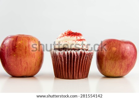 red apple vs red velvet cupcake - snack decision between healthy food or junk food