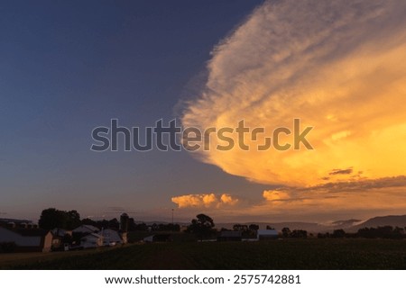 Similar – Image, Stock Photo Thunderstorm over the hill . Only a small bright glow over the blue black rain clouds, the rainforest.  As if the world wanted to end.