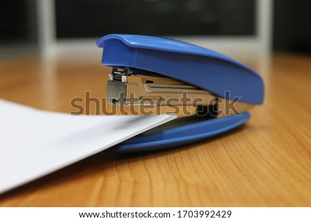 Photo of blue stapler put on the table in office, stapler is a device used in schools or offices  Photo stock © 