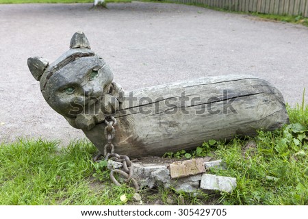 KOBRINO, RUSSIA -  AUGUST 08, 2015: Photo of Cat scientist. Wooden sculpture in the courtyard of the house of Pushkin\'s nanny Arina.