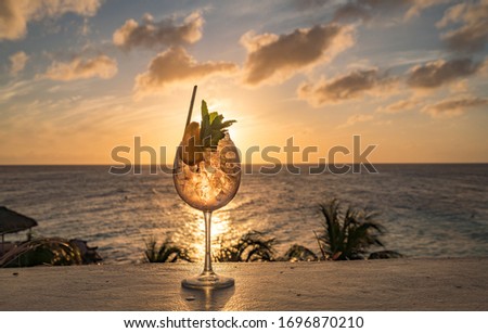 Cocktail at Sunset overlooking the Caribbean Sea on Curacao 