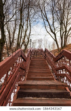 Wooden red staircase in Kolomenskoye Park in late autumn. Without man. Russia, Moscow, November 2020