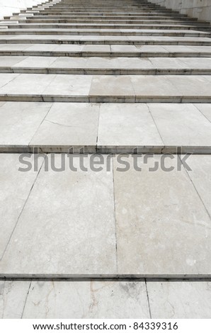 forefront of a long staircase built from blocks of marble
