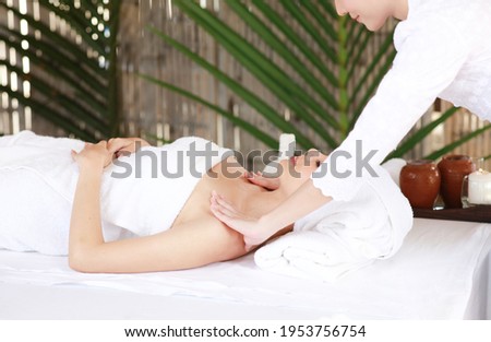 Young woman enjoying massage in spa salon, famouse traditional Thai massage service