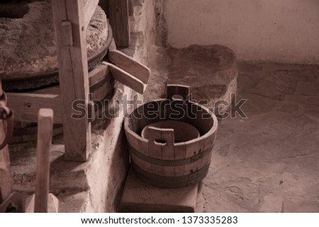 bucket to receive milled grain in sepia tone