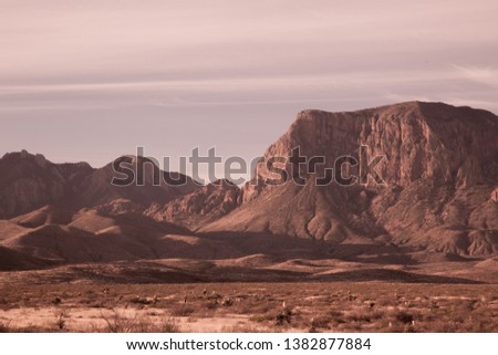 Desert mountain with clouds in the sky in sepia tone