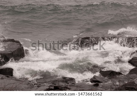 Waves on a rocky shore in sepia tone
