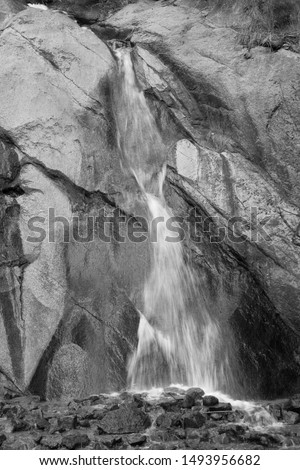 Waterfall in rocky mountains in black and white Stock foto © 