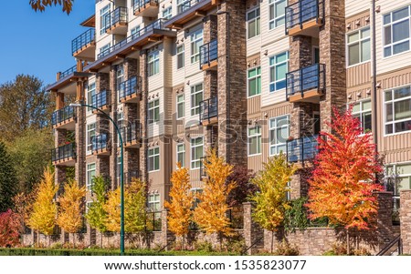 Houses in suburb with Fall Foliage in the north America. Luxury houses with nice yellow and red coloured landscape.