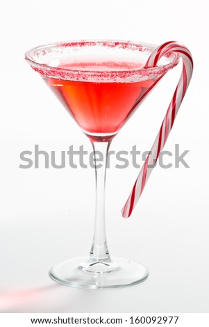 Holiday martini isolated on a white background with a red and white sugar rim