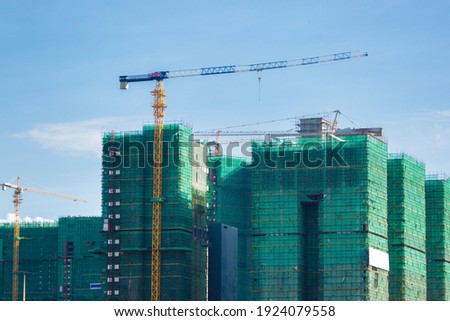 Image of a building in progress with security net around it. High building in progress.