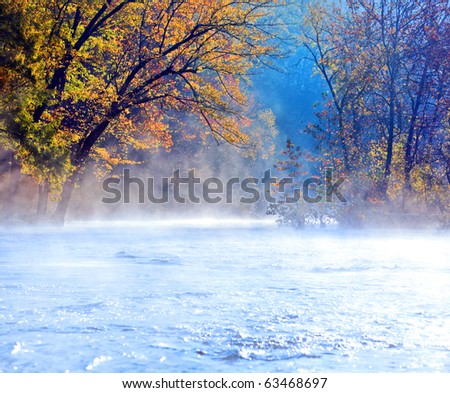 Beautiful scenic river in fall with early morning mist