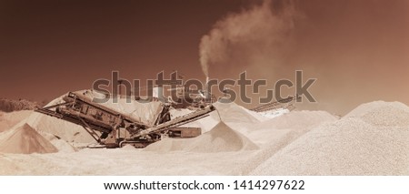 Stone crushing equipment at the limestone quarry, monochrome panoramic image of a light brown color, sepia. Mining industry.