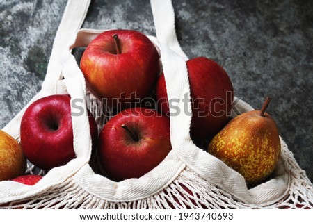 Apples starking in the mesh bag over a metal background. Sustainability and conscious consuming concept. Top View. Flat Lay