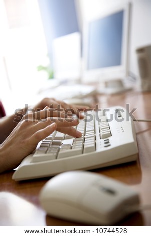 female hands using keyboard in an office environment