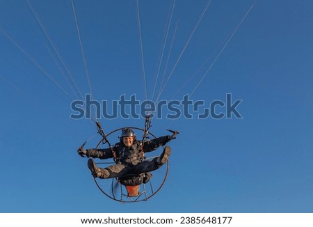 Similar – Image, Stock Photo paragliding man with orange paraglider against the sun
