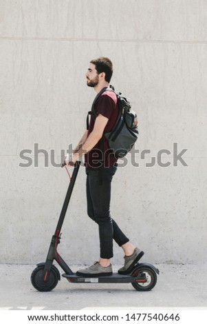 Similar – Image, Stock Photo Man riding an e-scooter