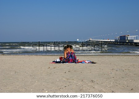 MAMAIA  BEACH, THE BLACK SEA, ROMANIA - SEPTEMBER 15, 2014. Autumn at the Black Sea. People relaxing on  the Beach Mamaia, Romania.