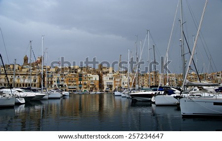 MALTESE ISLAND,EUROPE - NOVEMBER 6, 2014. Gloomy evening in  the Mediterranean Sea on the Maltese  coast ,with ships and yachts  in the harbor.