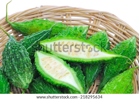 Bitter Cucumber, Balsum Pear , Bitter gourd (Momordica charantia L.) in rattan basket on white background