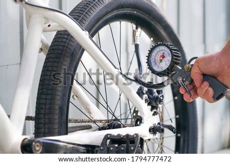 Similar – Image, Stock Photo Inflate bike tires
