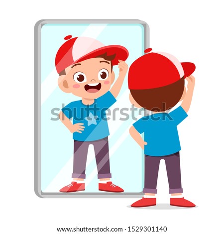 happy cute kid boy use mirror in morning