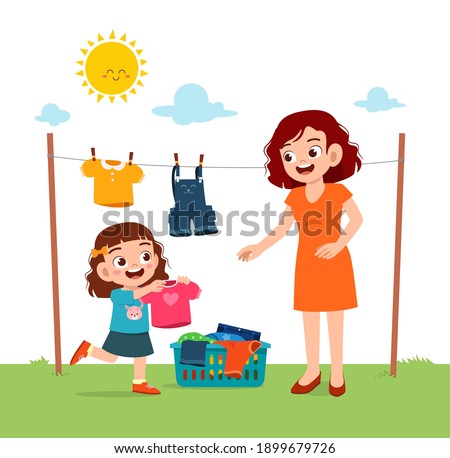 little kid helping mother to dry the clothes outside