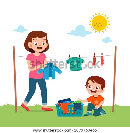 little kid helping mother to dry the clothes outside