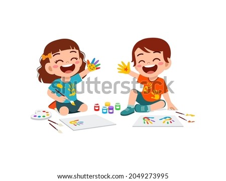 cute little boy and girl using paint to hand for art