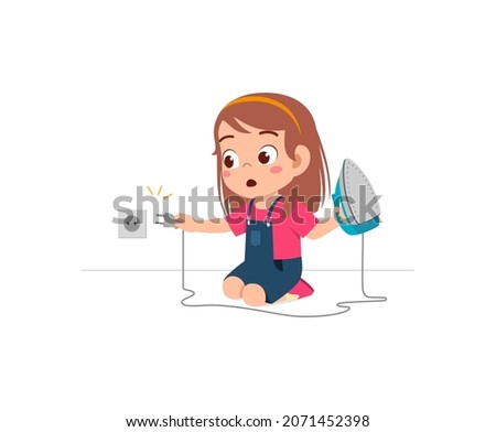 little girl curious to plug in electric iron to wall outlet