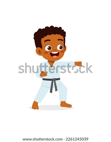 cute little kid training and showing karate pose