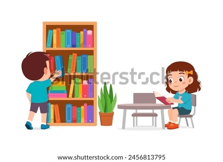 little kid read book in the library with friend