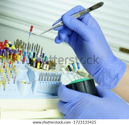 An endodontist physician places the endodontic instruments in a sterile box. A set of hand tools placed in a sterile box. Imagine de stoc © 
