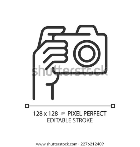 Hand with camera pixel perfect linear icon. Person taking shot with analog equipment. Photographer tool. Thin line illustration. Contour symbol. Vector outline drawing. Editable stroke